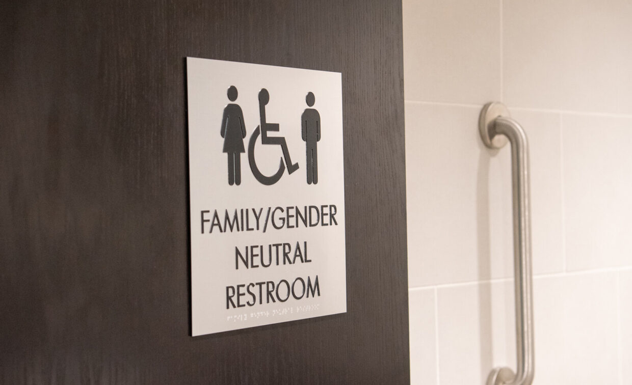 A sign on a dark door reads